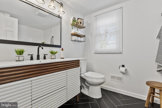 bathroom with tile patterned floors, vanity, and toilet