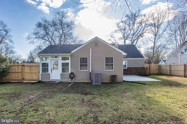 back of house with central air condition unit, a yard, a fenced backyard, and a patio