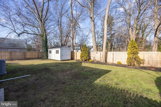 view of yard featuring a fenced backyard, an outdoor structure, and a storage shed