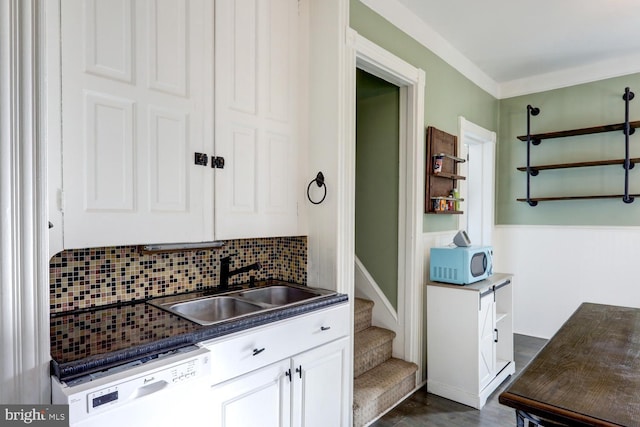 kitchen featuring white appliances, backsplash, dark wood-type flooring, white cabinets, and sink