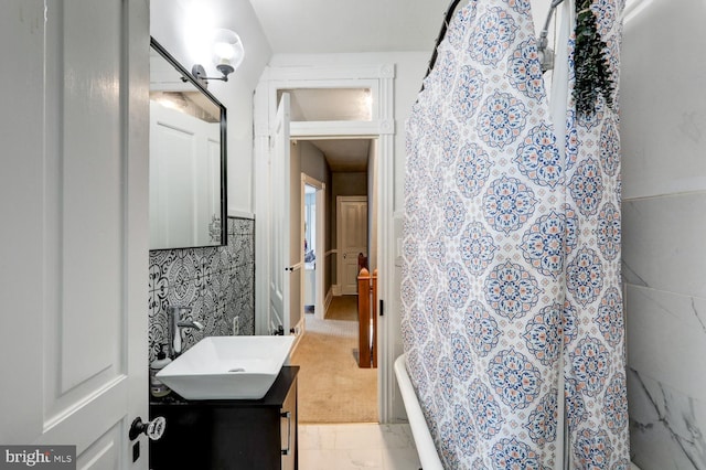 bathroom with curtained shower and vanity