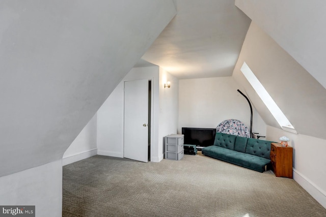 living area with carpet flooring and vaulted ceiling with skylight