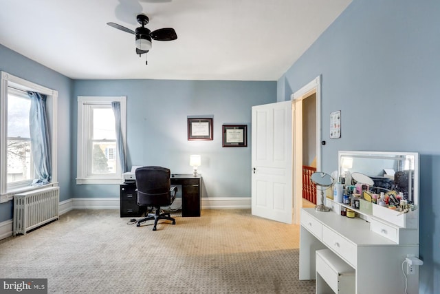 office with light carpet, radiator heating unit, and ceiling fan