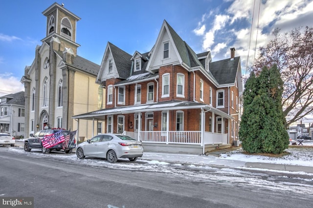 victorian house featuring a porch