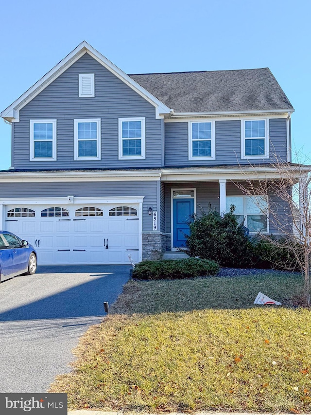 view of front of house featuring a garage and a front lawn