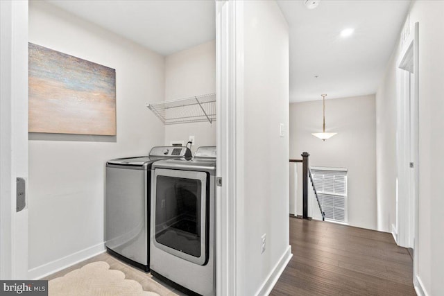 laundry area featuring hardwood / wood-style floors and washing machine and clothes dryer