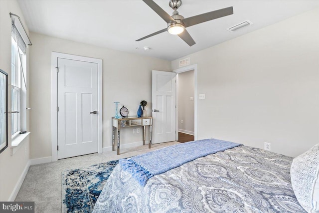 bedroom with ceiling fan and light colored carpet