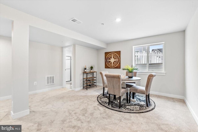 dining room with light colored carpet