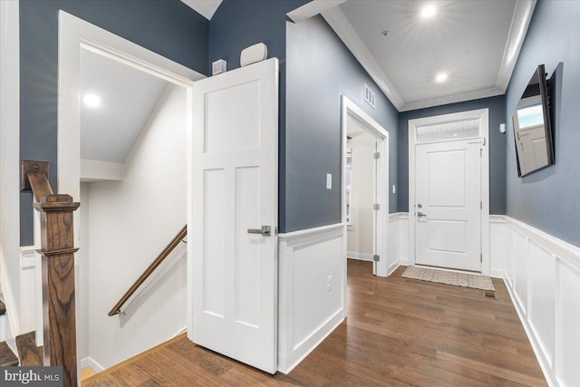 hallway with dark hardwood / wood-style flooring and crown molding