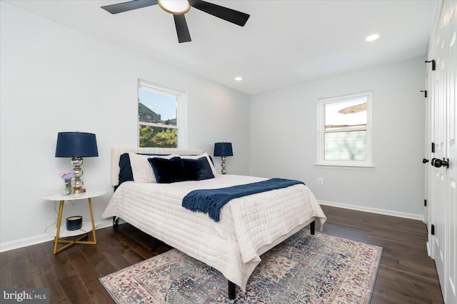 bedroom with dark hardwood / wood-style floors and ceiling fan