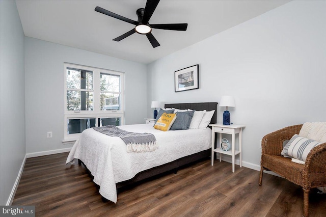 bedroom with dark hardwood / wood-style flooring and ceiling fan