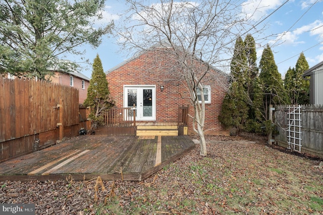 rear view of house featuring a wooden deck