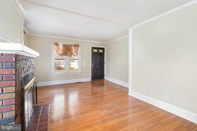 unfurnished living room featuring a fireplace, hardwood / wood-style floors, and ornamental molding