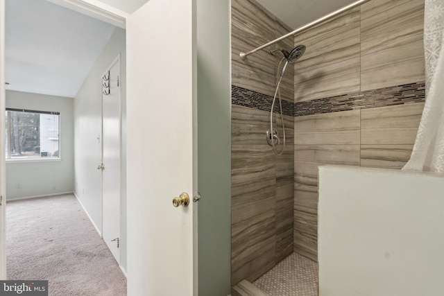 bathroom with a tile shower