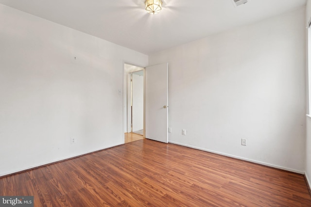 unfurnished room with hardwood / wood-style flooring