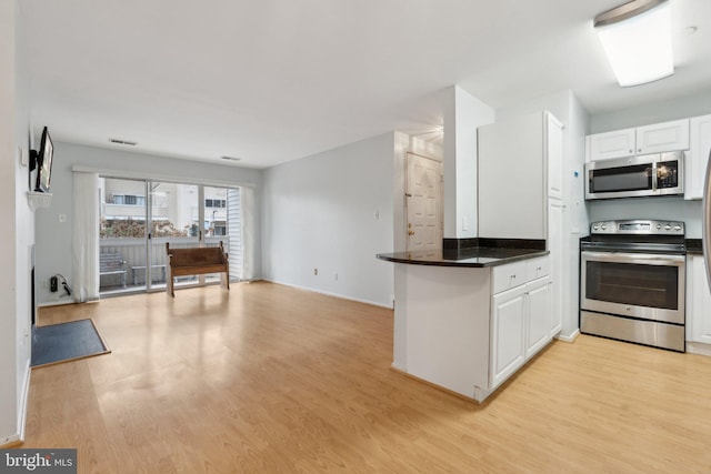 kitchen featuring white cabinetry, appliances with stainless steel finishes, and light hardwood / wood-style flooring