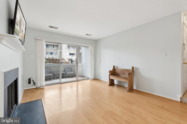 unfurnished living room with light hardwood / wood-style flooring