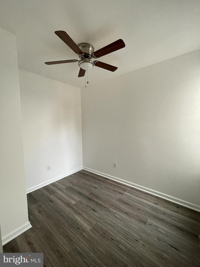 empty room with ceiling fan and dark hardwood / wood-style flooring