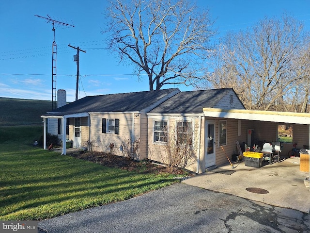 exterior space featuring a yard and a carport