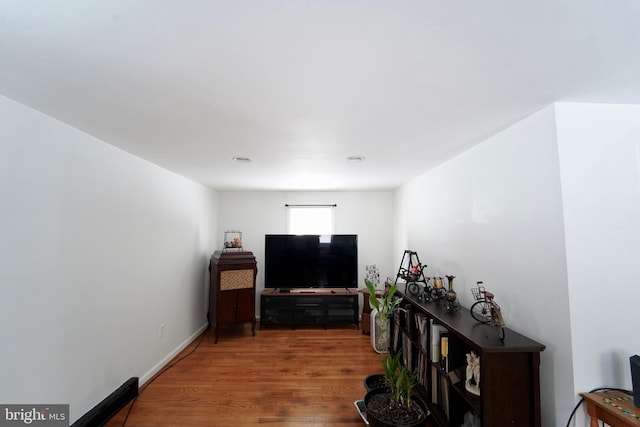 corridor with hardwood / wood-style flooring