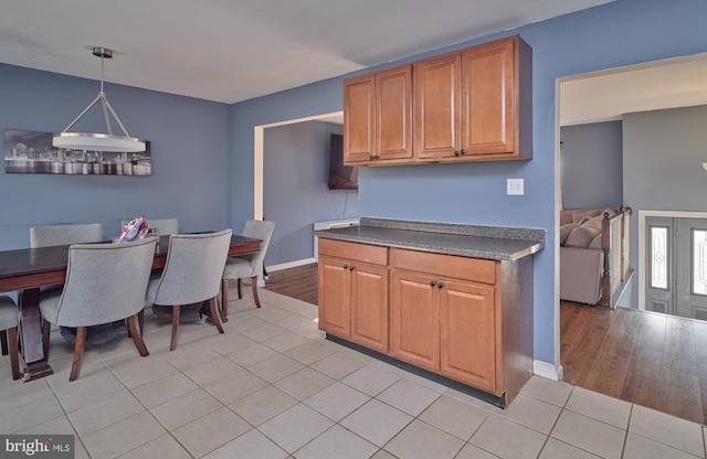 kitchen with decorative light fixtures and light tile patterned floors