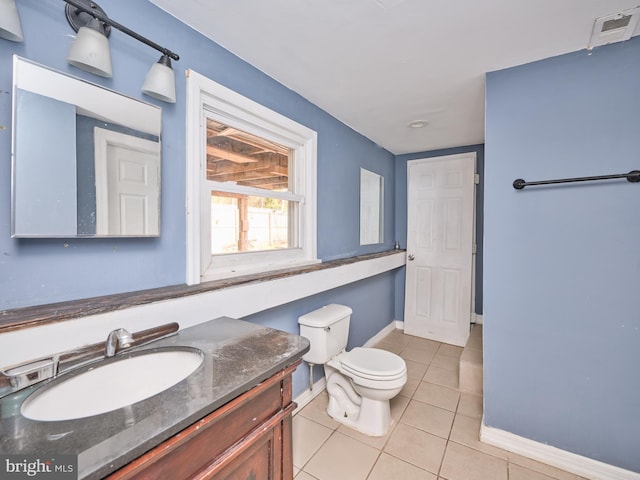 bathroom with tile patterned flooring, vanity, and toilet