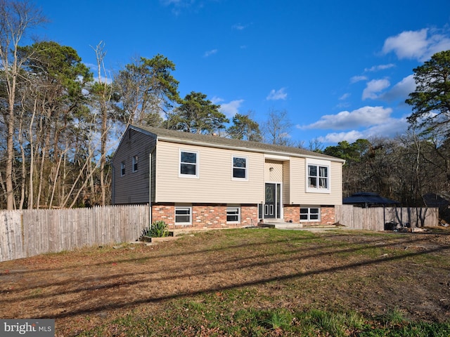 raised ranch with a front yard