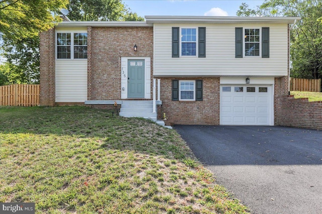 split foyer home featuring a front lawn and a garage