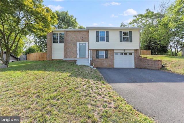 bi-level home featuring a front yard and a garage