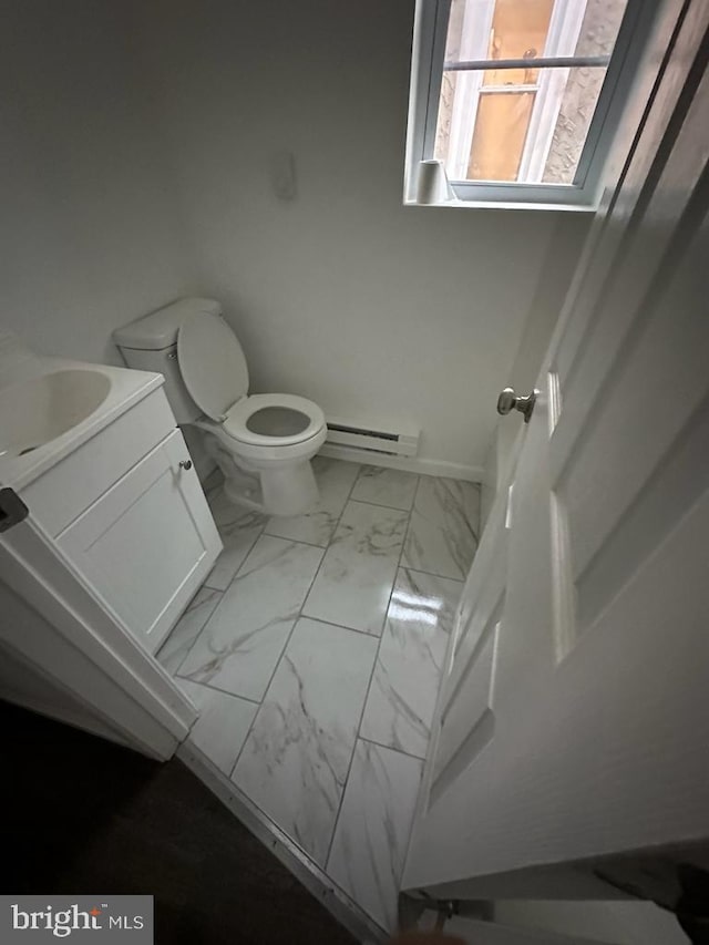 bathroom featuring vanity, a baseboard radiator, and toilet