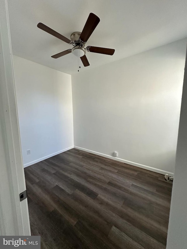 spare room with ceiling fan and dark hardwood / wood-style floors