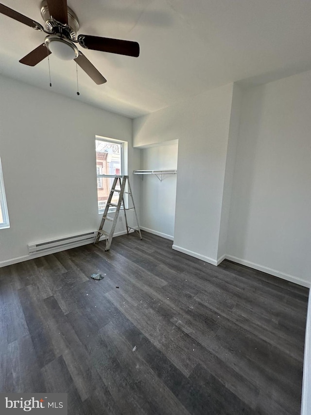 unfurnished room featuring a baseboard radiator, ceiling fan, and dark wood-type flooring