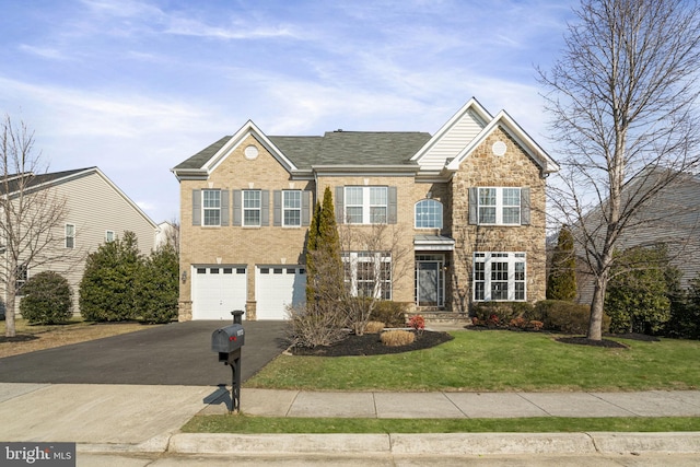 view of front of property featuring a garage and a front yard