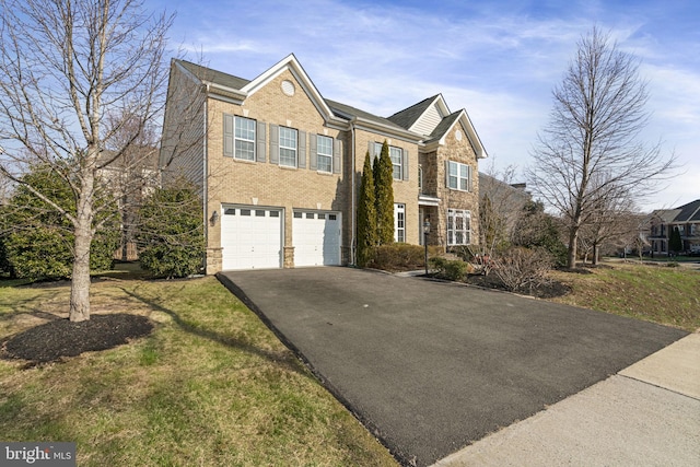 view of front facade with a garage and a front lawn