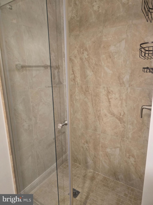 bathroom with a shower with shower door