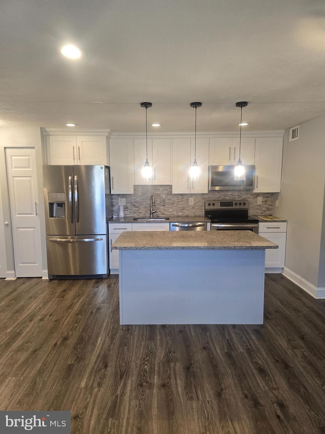 kitchen with white cabinetry, sink, pendant lighting, and appliances with stainless steel finishes