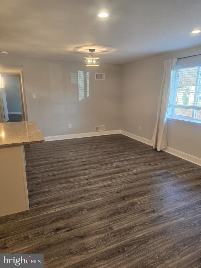 spare room featuring dark hardwood / wood-style floors