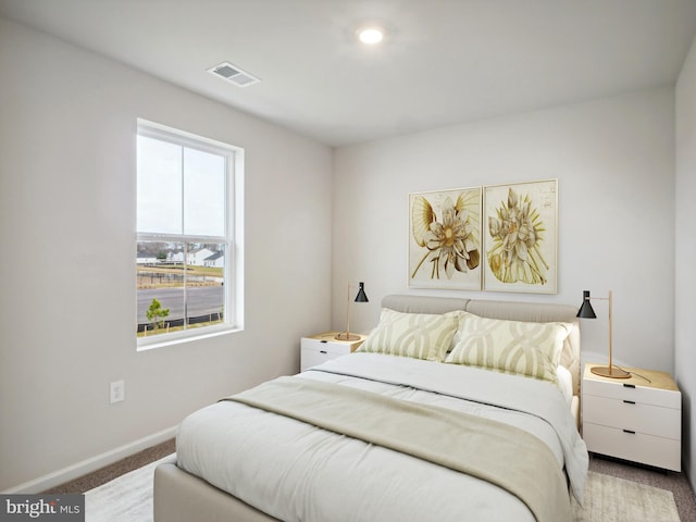 carpeted bedroom featuring multiple windows