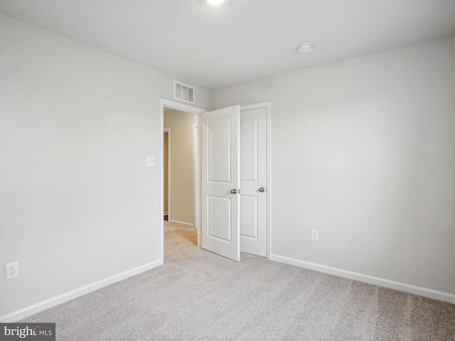 unfurnished bedroom featuring light colored carpet