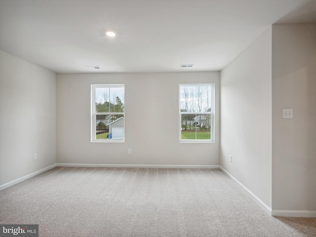 spare room with light carpet and a healthy amount of sunlight