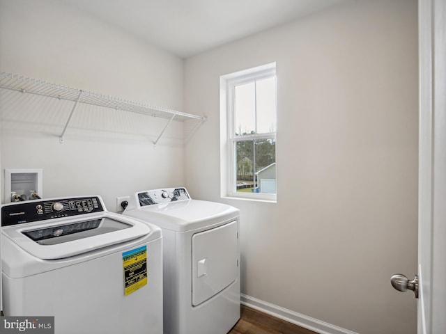 laundry area with washer and dryer and dark hardwood / wood-style flooring