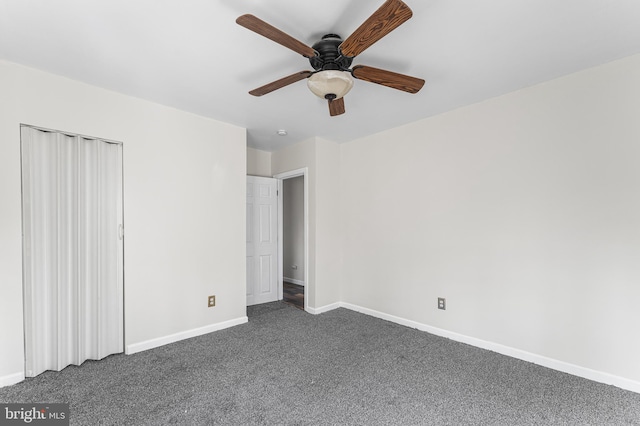 unfurnished bedroom with dark colored carpet and ceiling fan