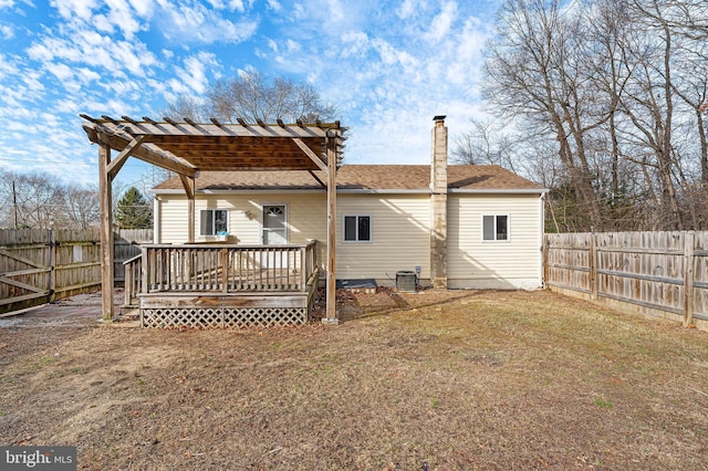 back of house with a pergola, central air condition unit, a deck, and a lawn