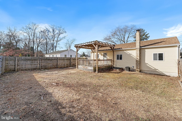 rear view of property featuring a lawn, a pergola, a wooden deck, and central air condition unit