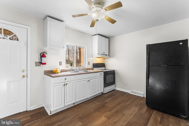 kitchen featuring white cabinets, black refrigerator, sink, white range with electric stovetop, and dark hardwood / wood-style flooring