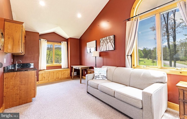 living room featuring sink, light colored carpet, and vaulted ceiling