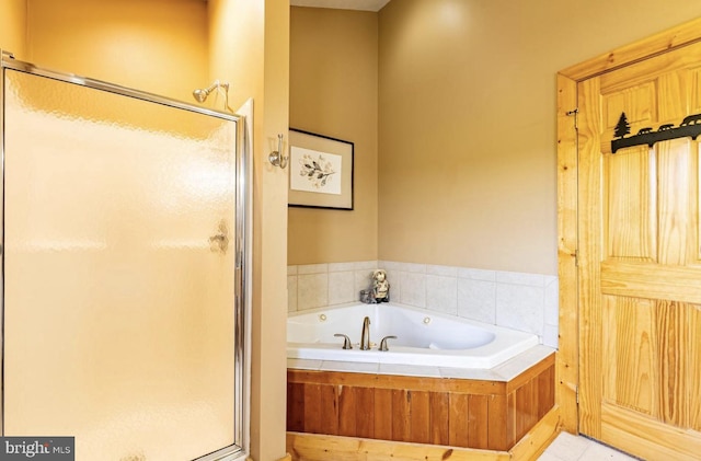 bathroom with tile patterned floors and independent shower and bath