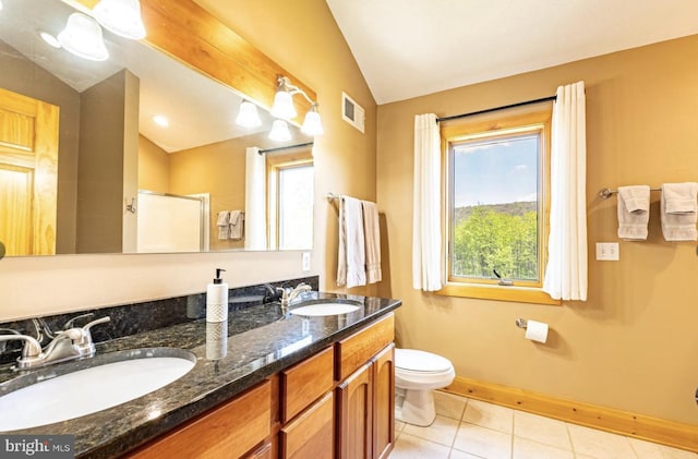 bathroom with tile patterned flooring, vaulted ceiling, toilet, a shower with door, and vanity