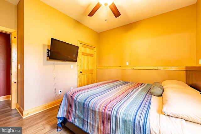 bedroom with ceiling fan and hardwood / wood-style floors