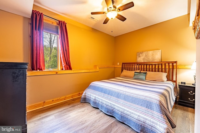 bedroom with hardwood / wood-style floors and ceiling fan